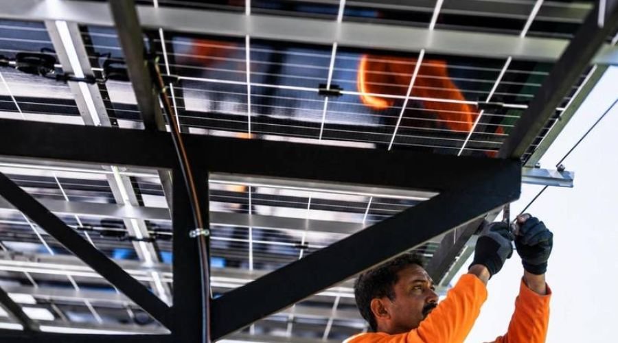 Technician installing solar panels on a mounting structure
